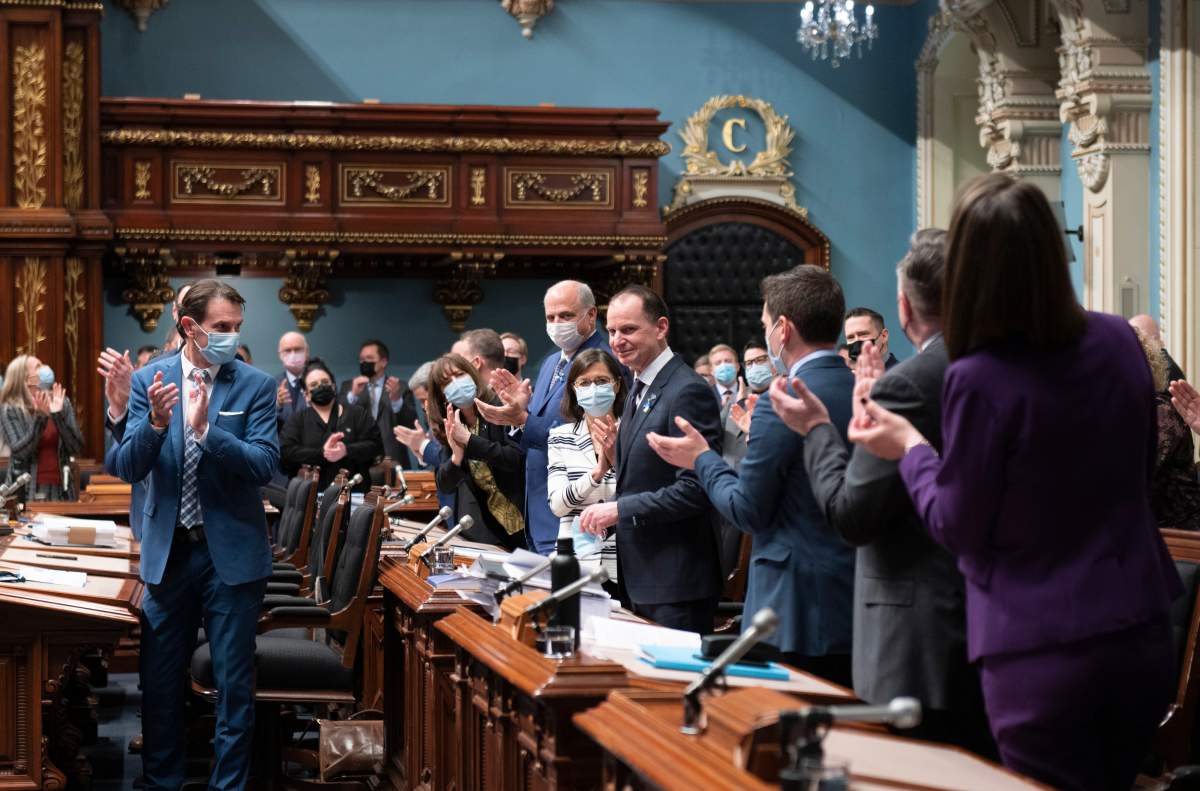 Quebec Finance Minister Eric Girard, centre is applauded by members of the government as he presents the government’s budget.