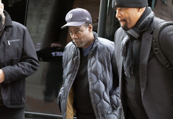 Chris Rock, center, arrives at the Wilbur Theater before a performance, Wednesday, March 30, 2022, in Boston. 