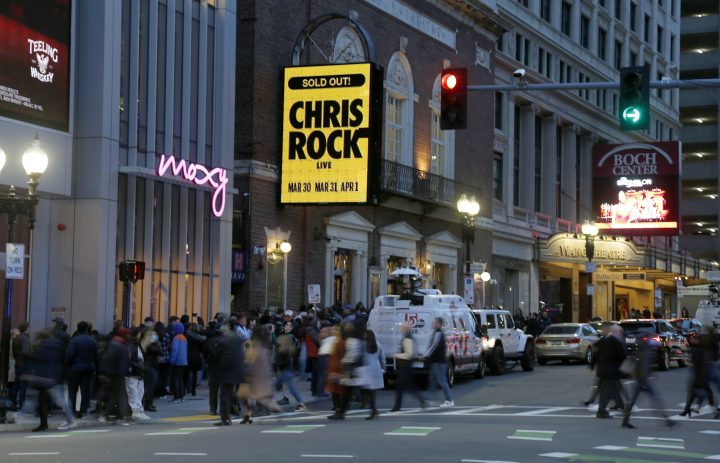 The marquee advertises Chris Rock as ticket holders wait to enter outside the Wilbur Theatre, Wednesday, March 30, 2022, in Boston.