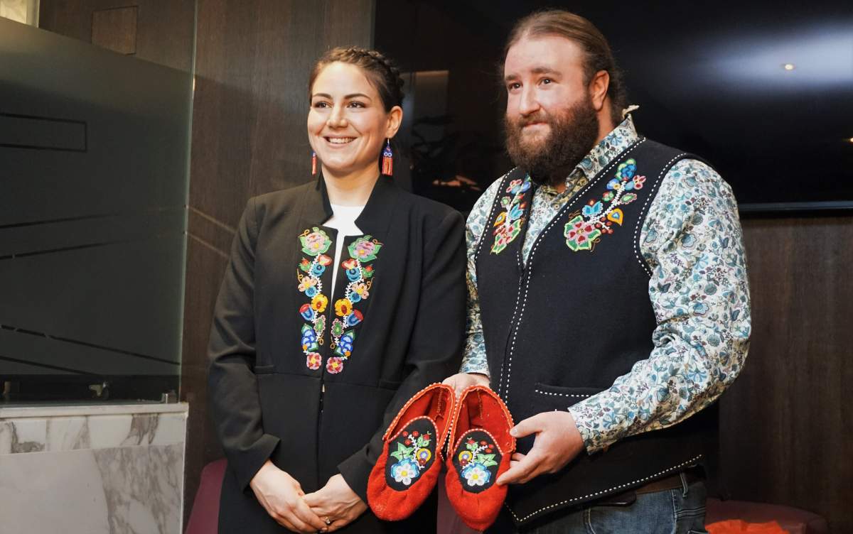 Métis National Council President Cassidy Caron wears the new jacket gifted to her by Métis historian and delegate Mitchell Case at their hotel in Rome on March 28, 2022, before their private audience with Pope Francis. Case also holds the moccasins he made that were gifted to the pontiff.
