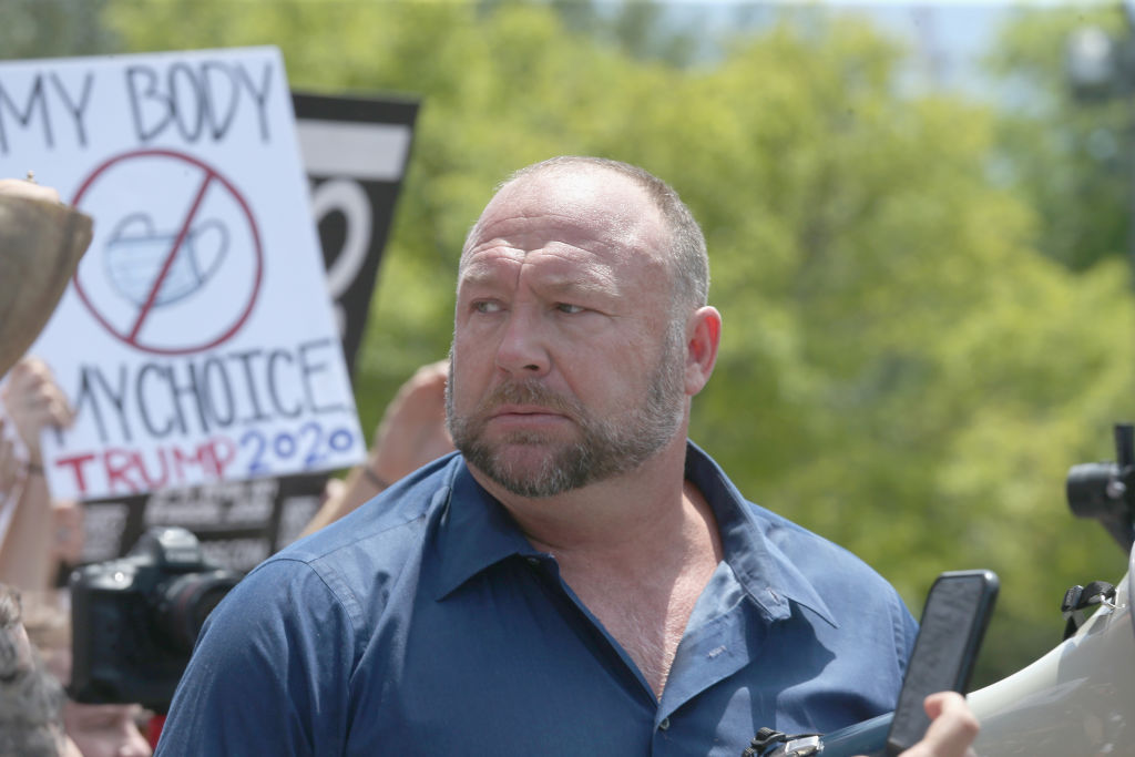Alex Jones speaks to protestors gathered outside the Texas State Capitol during a rally calling for the reopening of Austin and Texas on April 25, 2020 in Austin, Texas.