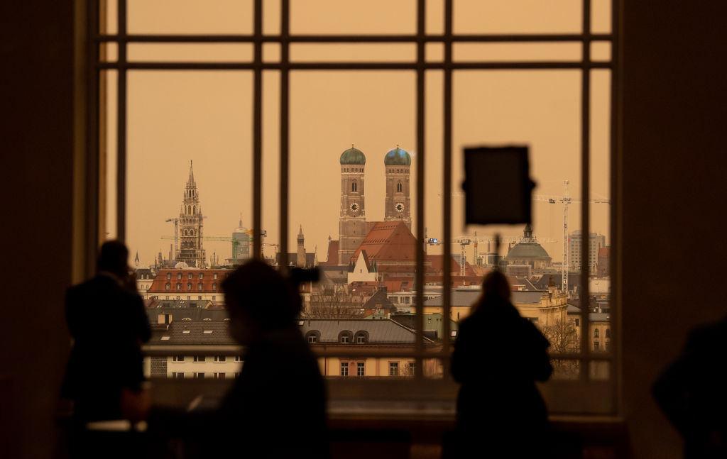 Journalists stand in front of a window in the Bavarian parliament.