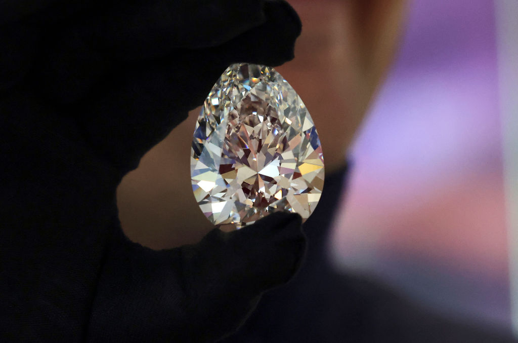 A Christie's auction house staff member displays for the media a giant diamond nicknamed "The Rock", in Dubai.