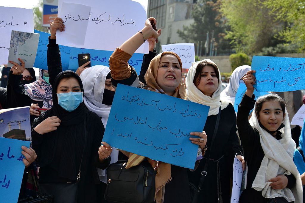 Afghan women and girls take part in a protest in front of the Ministry of Education in Kabul on March 26, 2022, demanding that high schools be reopened for girls.