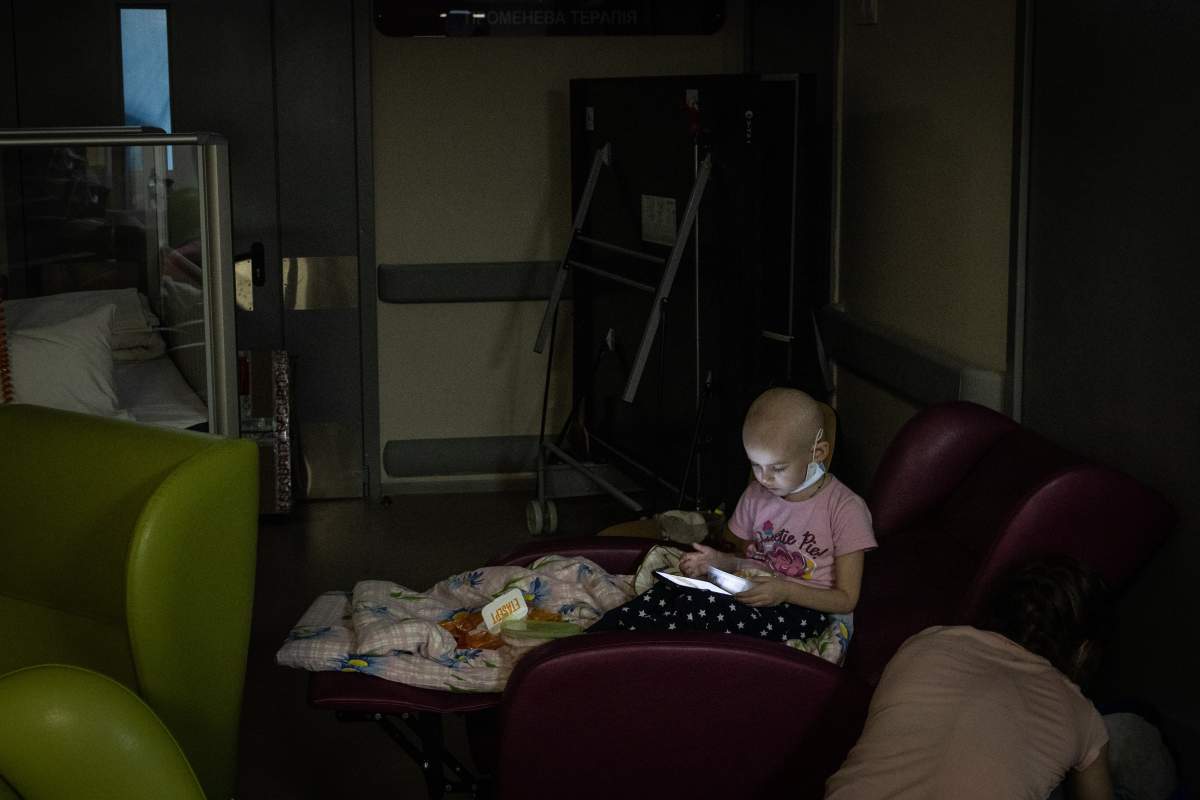 A child being treated for cancer plays with a cell phone in the bomb shelter of the Oncology ward at Okhmatdyt Children's Hospital on February 28, 2022 in Kyiv, Ukraine.