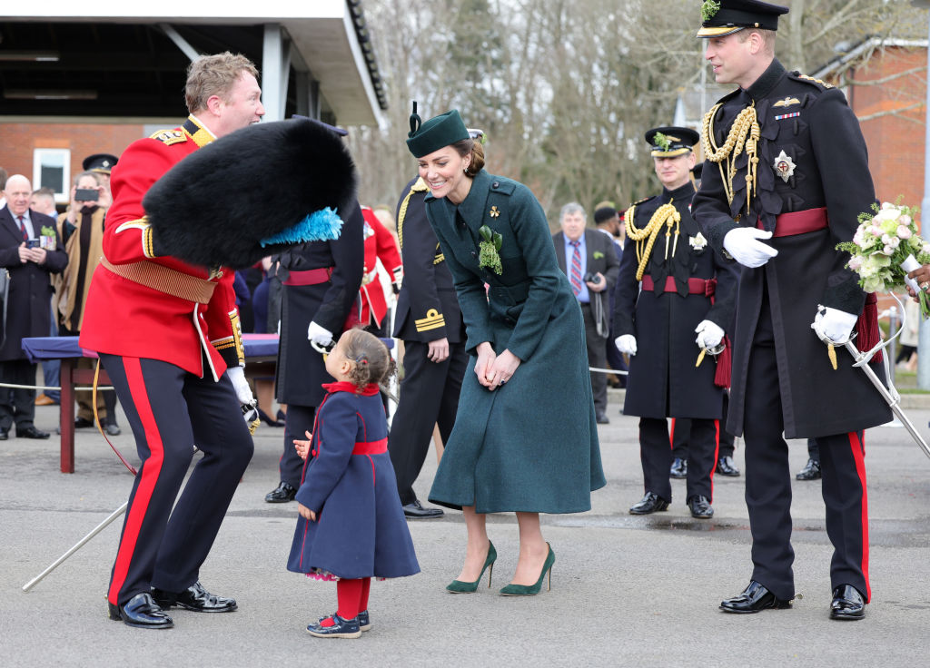 kate middleton expresses delight as a guard places his bearskin hat on a toddler