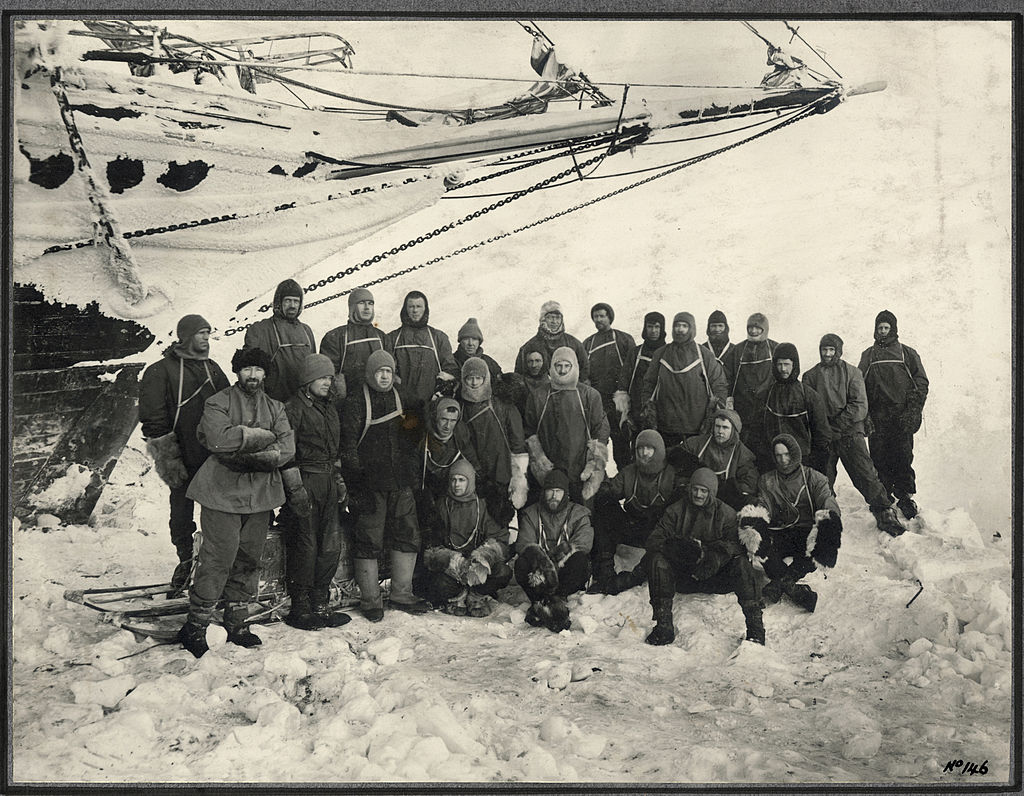 Officers and crew pose under the bow of the Endurance at Weddell Sea Base during the Imperial Trans-Antarctic Expedition. (Photo by Frank Hurley/Scott Polar Research Institute, University of Cambridge/Getty Images)