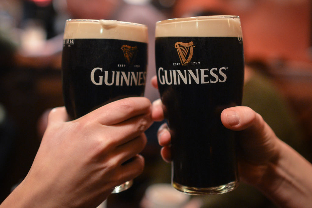 FILE - People enjoy a pint of Guinness on Tuesday, 19 December 2017, in Dublin, Ireland.
