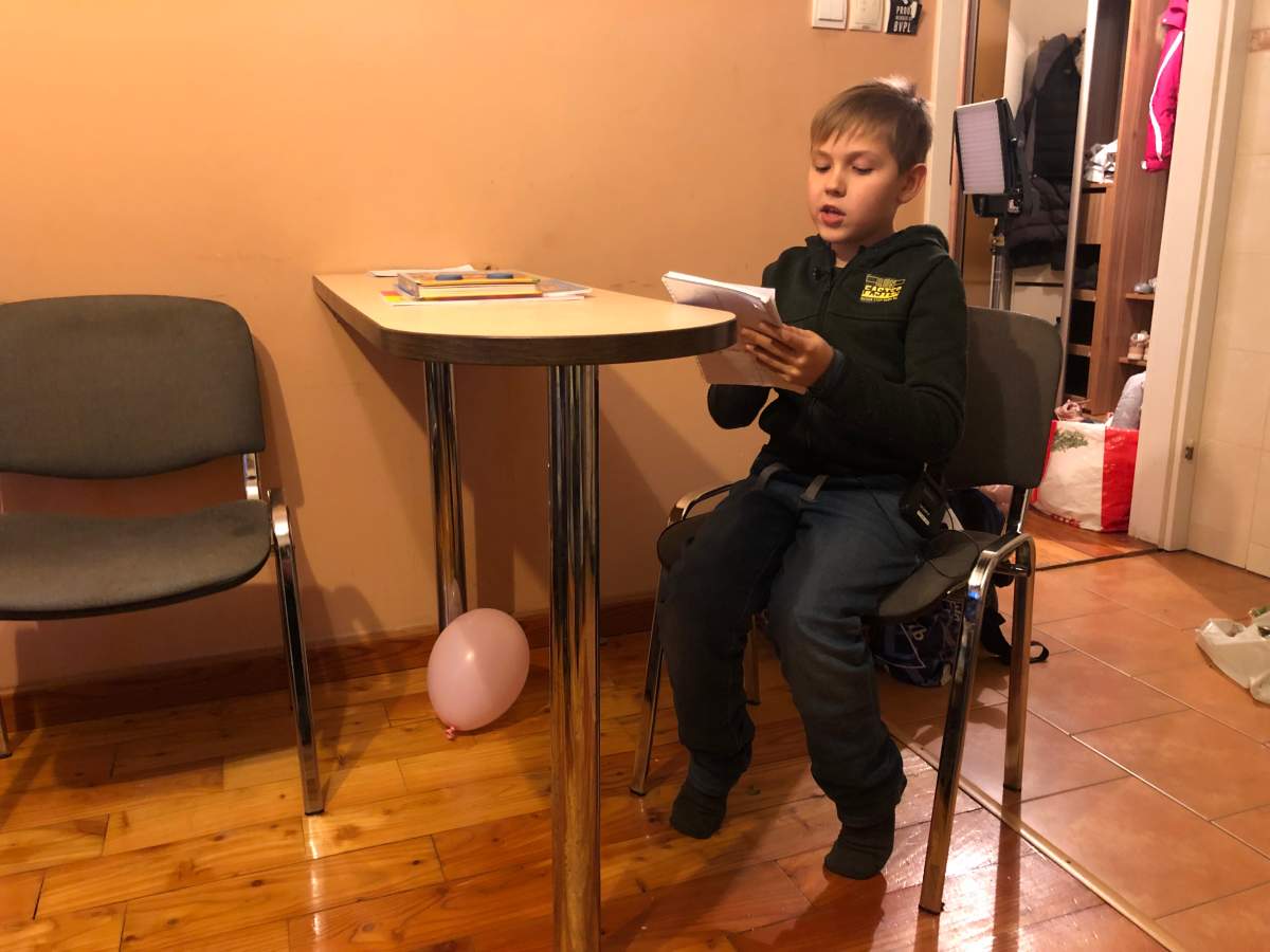 In Rzeszow, Poland, Platon Bihlenko, 9, reads a story he wrote about his family’s escape from Ukraine.