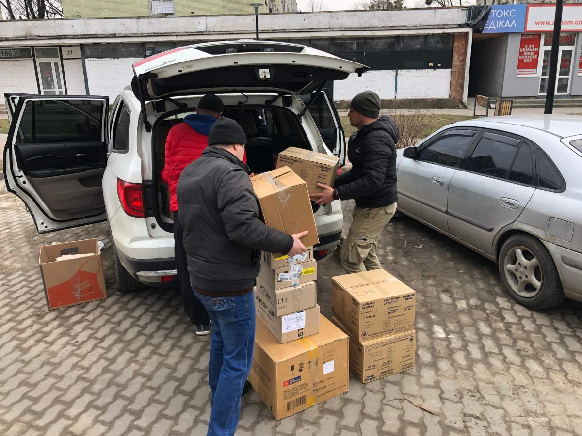 Roman Yosyfiv, right, outside a pharmacy loading medical supplies destined for Kharkiv into a vehicle in Lviv, Ukraine.