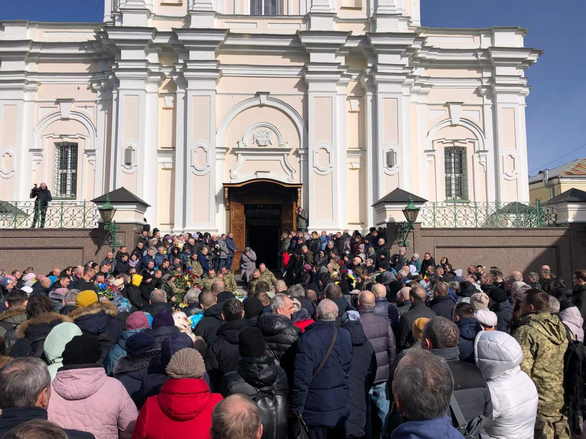 Mourners gather outside church to bid farewell to 2 soldiers killed by Russian airstrikes, Lutsk, Ukraine, March 12, 2022.