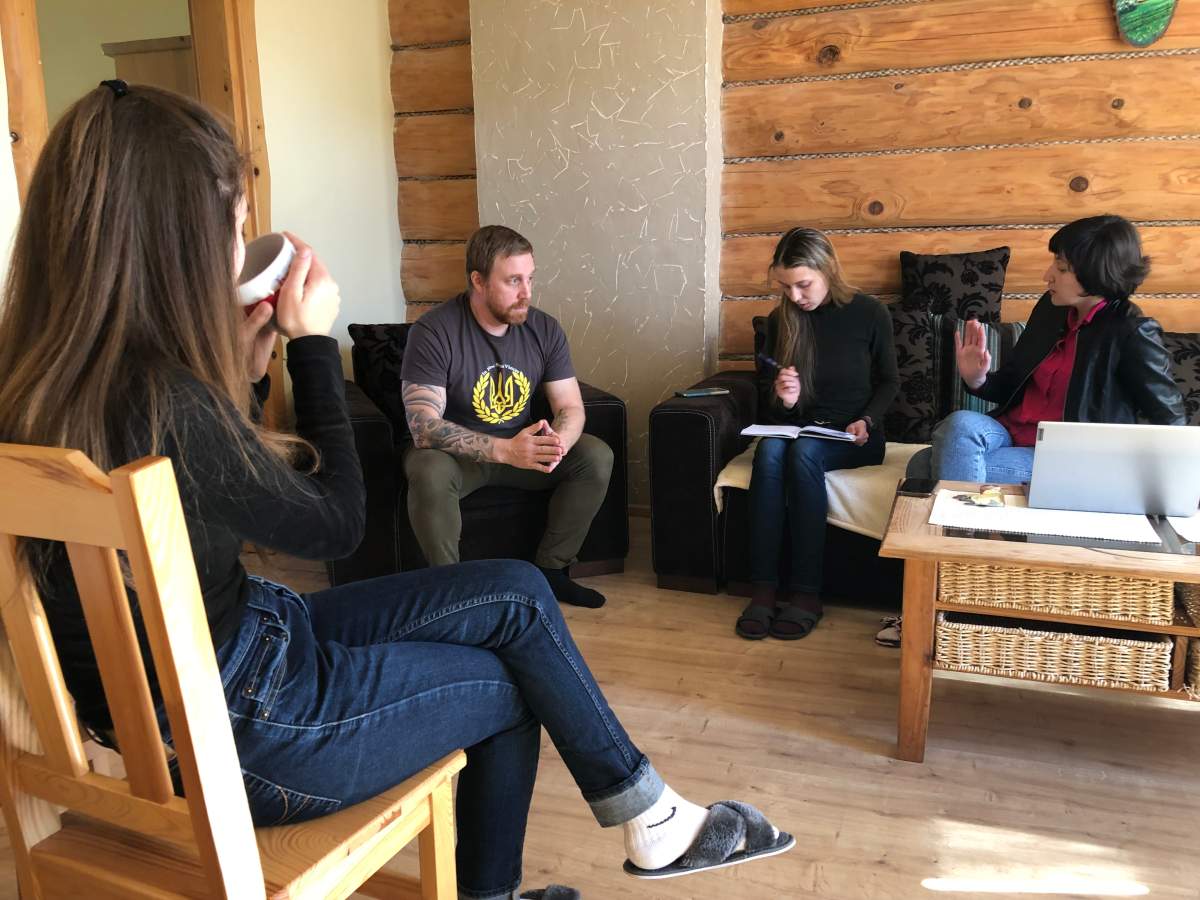 Kynan Walper and Tetiana Muzychuk, second from right, planing the evacuation of families from Mariupol, Ukraine, in Ustrzyki-Dolne, Poland, March 23, 2022.