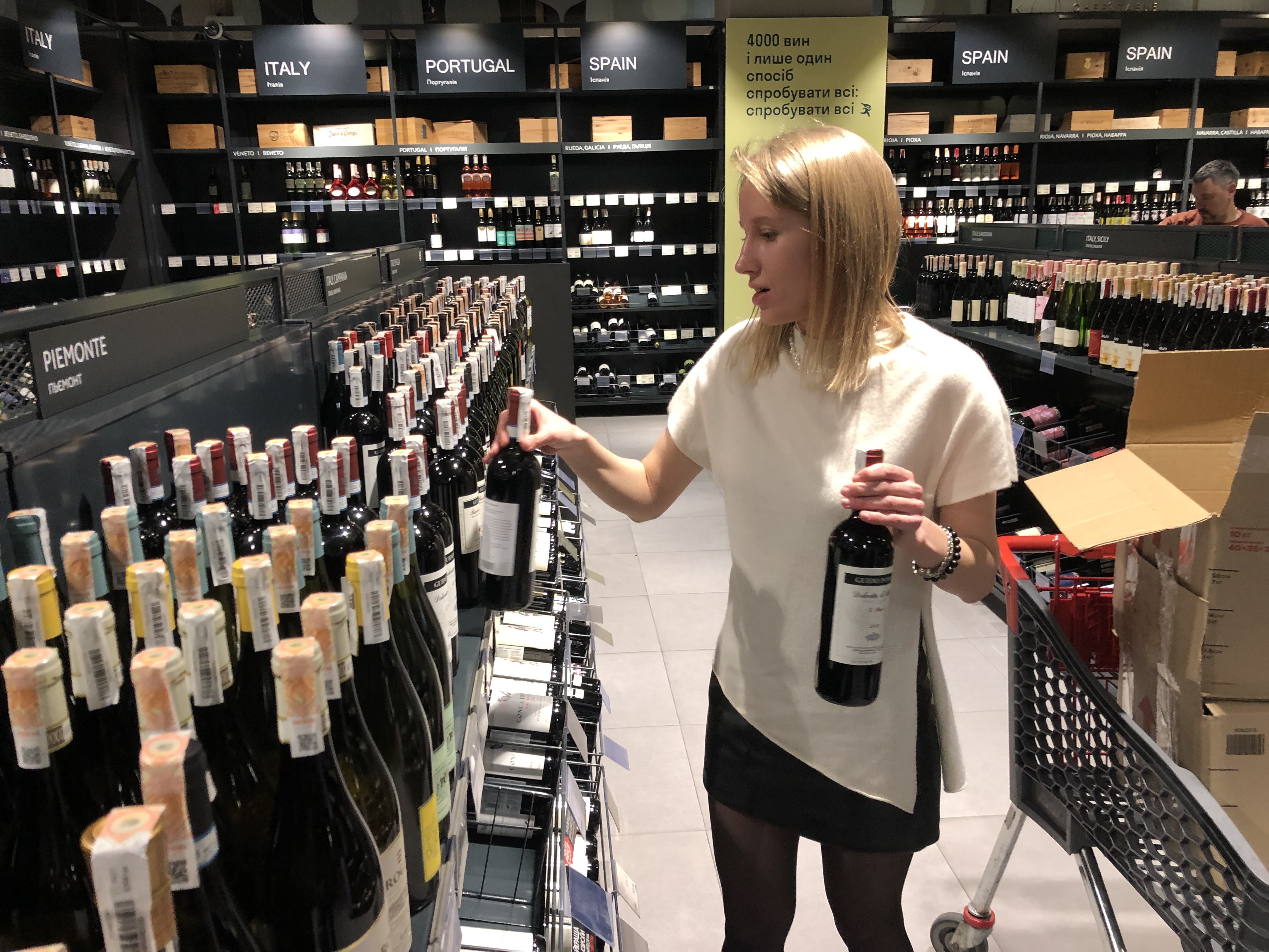 Kate Polanska stocks shelves as ban on alcohol sales was lifted in Kyiv on April 1, 2022.