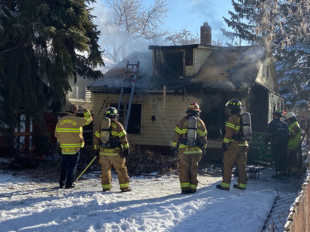 Edmonton firefighters battle a blaze at a property in the area of 97 Street and 111 Avenue Tuesday, March 29, 2020.