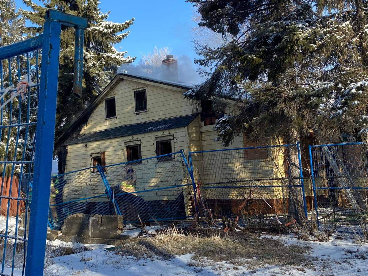 Edmonton firefighters battle a blaze at a property in the area of 97 Street and 111 Avenue Tuesday, March 29, 2020.