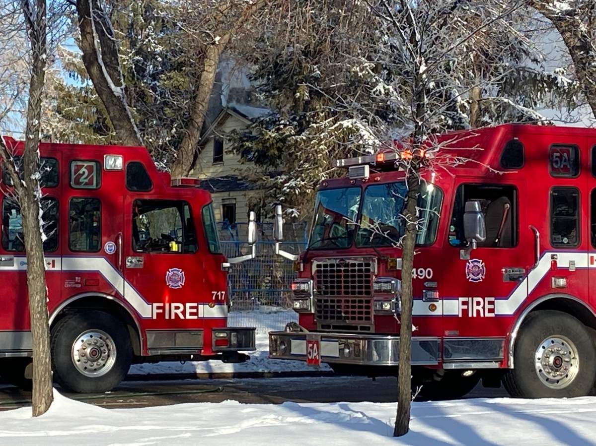 Edmonton firefighters battle a blaze at a property in the area of 97 Street and 111 Avenue Tuesday, March 29, 2020.