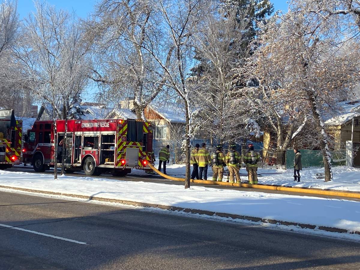 Edmonton firefighters battle a blaze at a property in the area of 97 Street and 111 Avenue Tuesday, March 29, 2020.