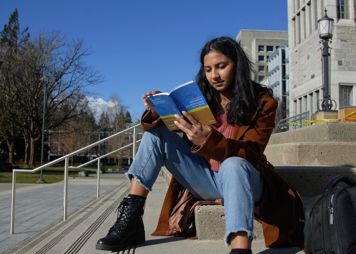 Rishika Bose reading on UBC’s campus. After completing her studies, she hopes to pursue a career in AI risk.