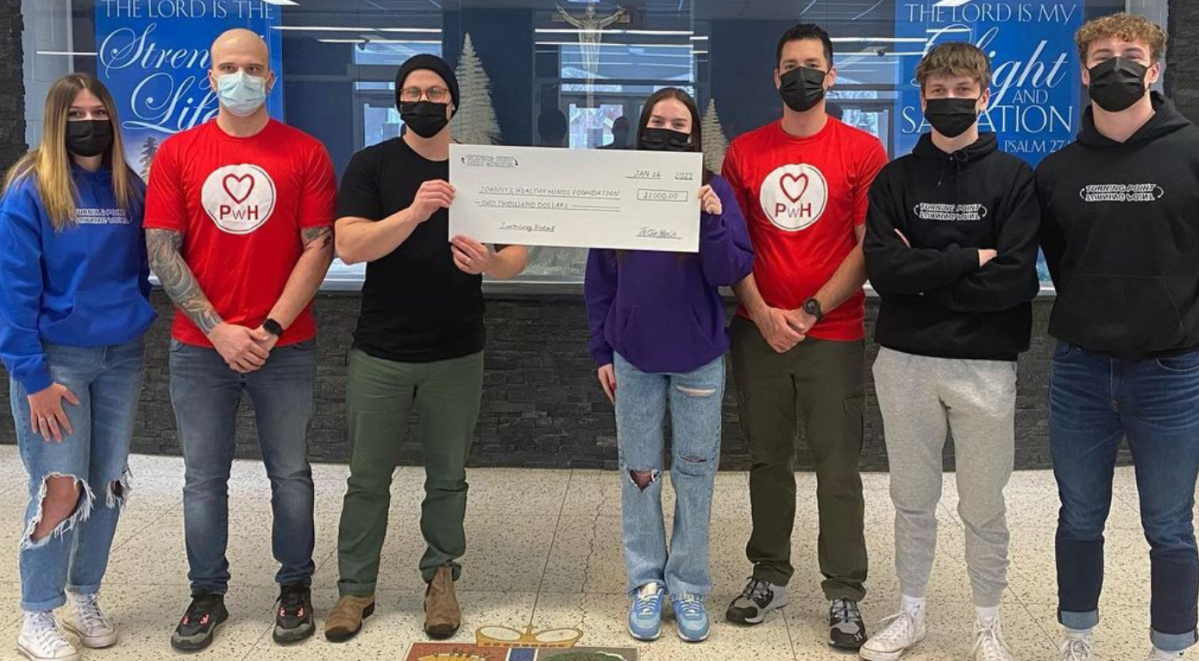 Turning Point members hand over a $2000 cheque to the Johnny Z Healthy Minds Fund.