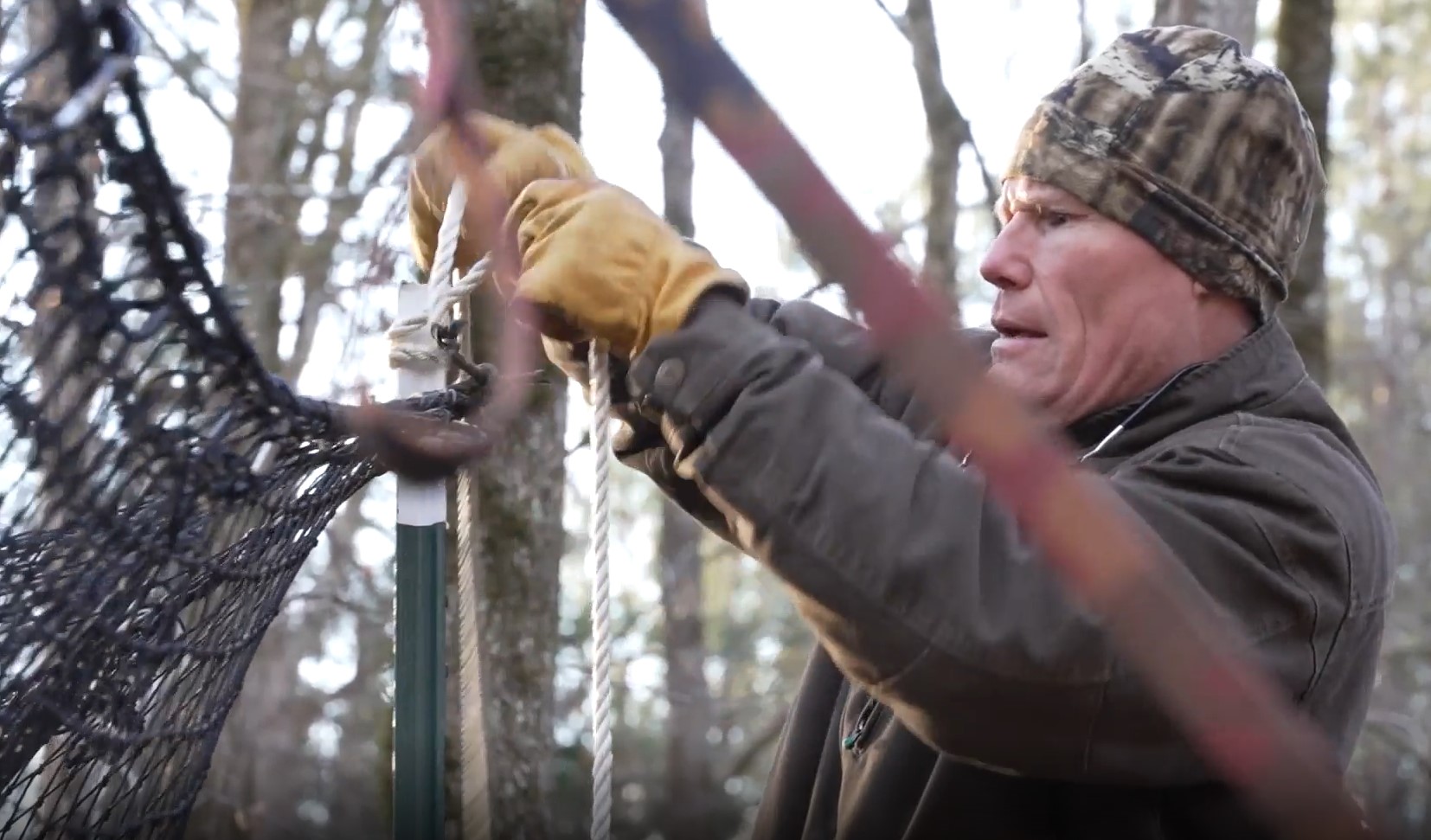Tony DeNicola is taking down a trap he set to catch feral pigs in South Carolina