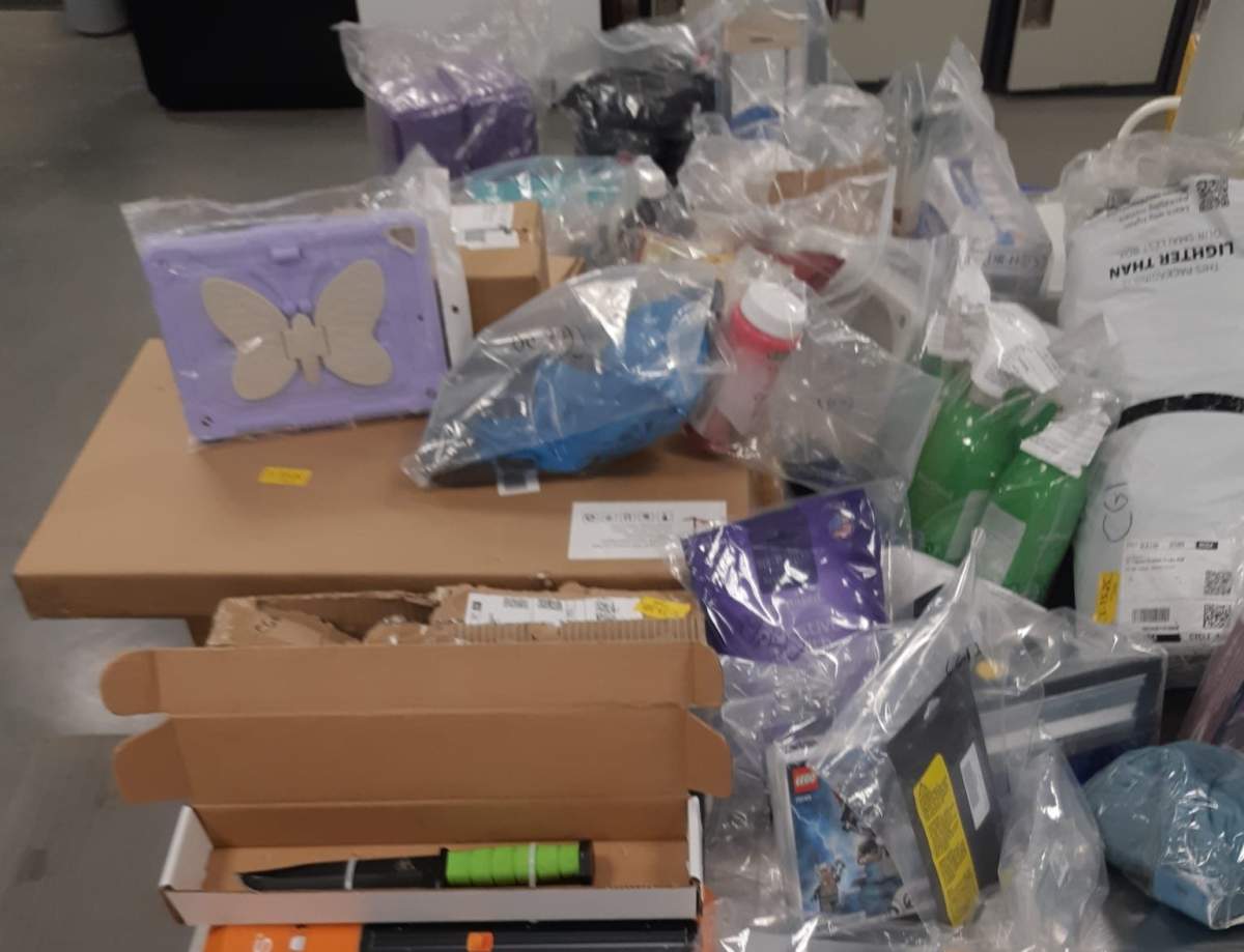 Items seized after four people were charged in connection with the armed carjackings of three Amazon delivery vehicles in Calgary in December 2021 and January 2022.