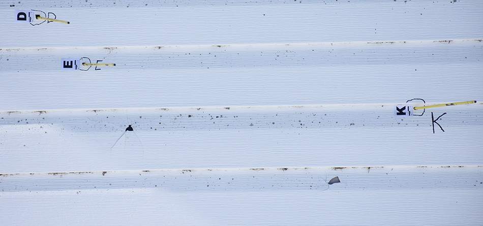 Police evidence of bullets fired into a Dakota Plains house.
