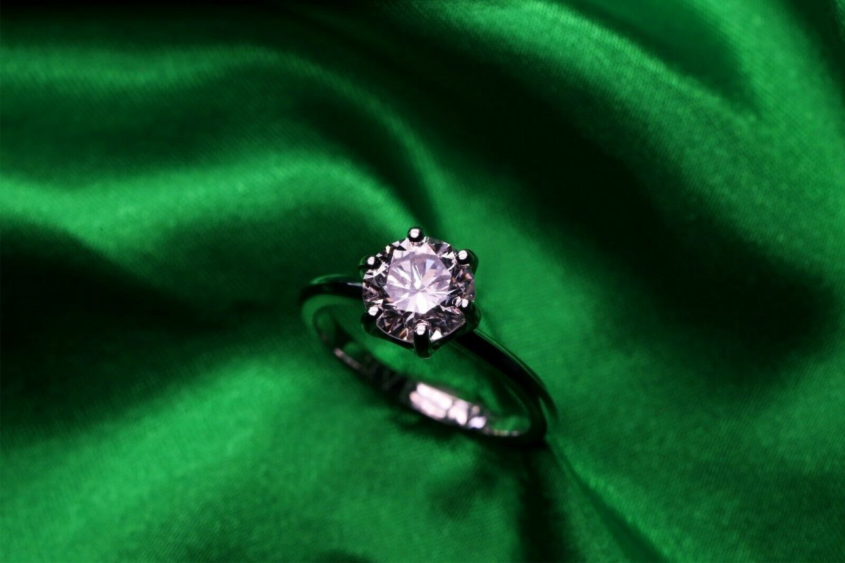The hidden valley ranch ring rests on a green cloth background.