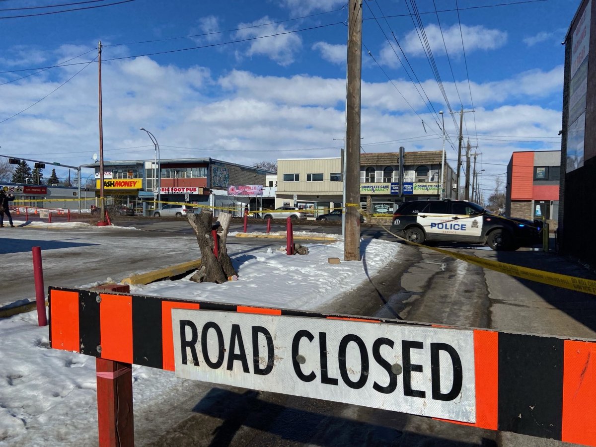 Police tape surrounds businesses on 118 Avenue in Edmonton as EPS investigate a homicide on March 12, 2022.