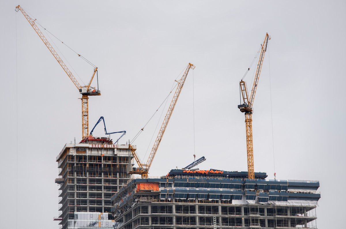 Cranes are shown on new construction projects in Montreal, Wednesday, February 2, 2022. 