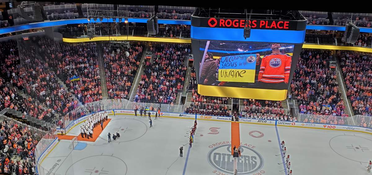The Axios Men’s Ensemble performs the Ukrainian national anthem at Rogers Place Mar. 5, 2022.