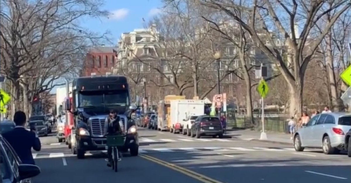 A cyclist slows the People's Convoy on March 20, 2022.