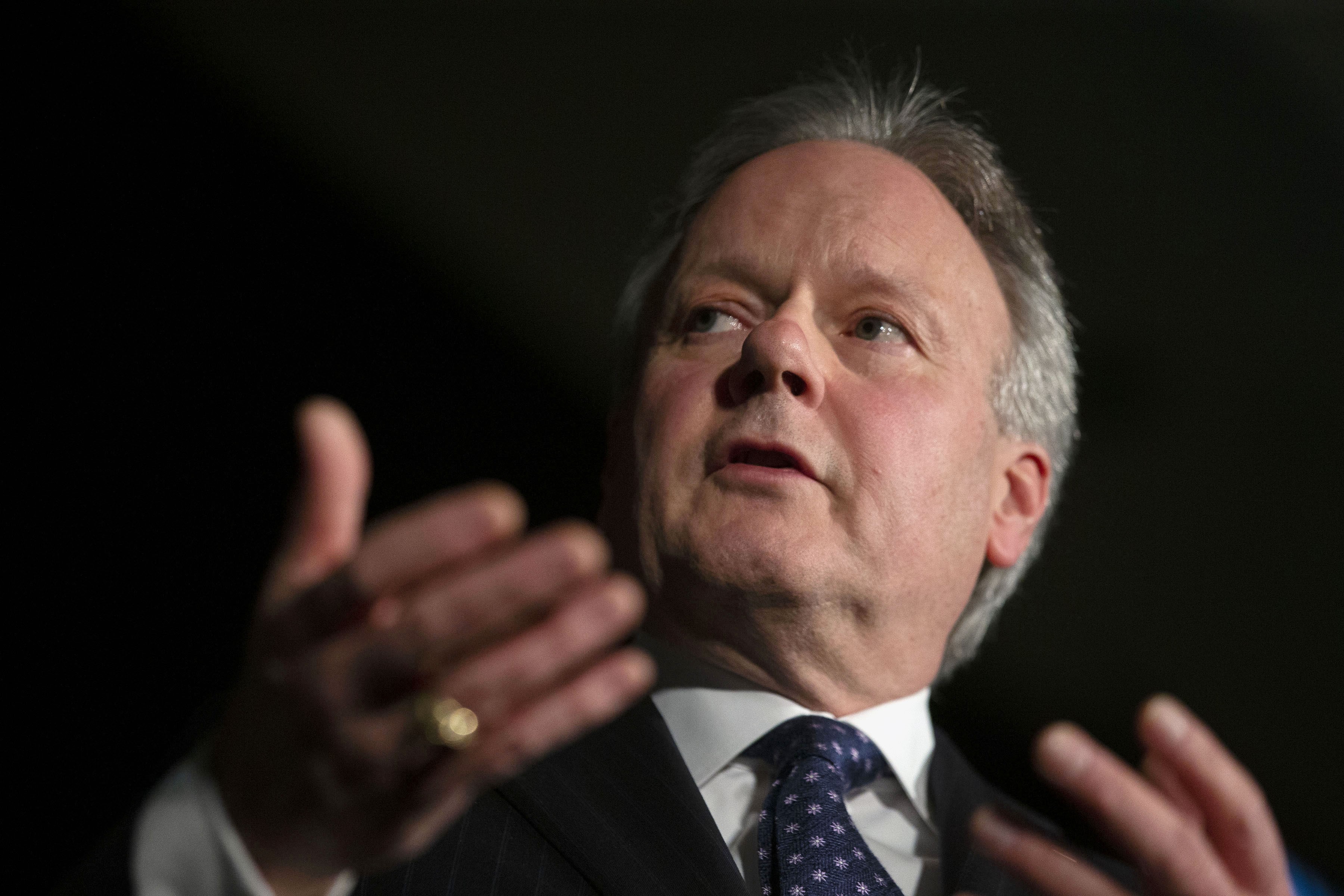 Stephen Poloz is visible from the shoulders up, looking into the distance.