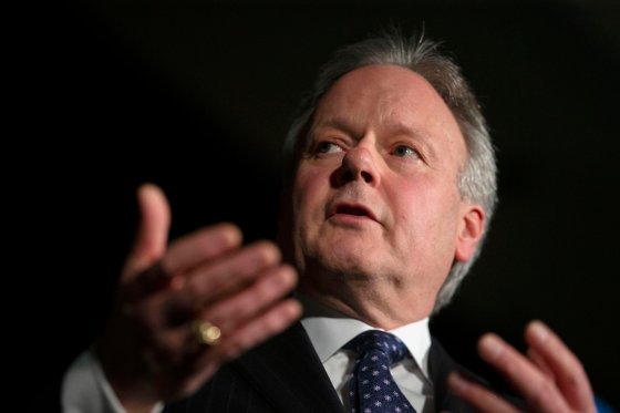 Stephen Poloz is visible from the shoulders up, looking into the distance.