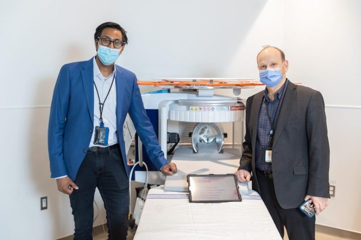 Dr. Aditya Bharatha, left, and Dr. Tim Dowdell pose with an example of the Hyperfine Swoop MRI machine in an undated handout photo. The new machine that St. Michael's Hospital received at the end of March is called Swoop, a portable MRI scanner created by Hyperfine in the U.S. that can be brought to the patient rather than the other way around.