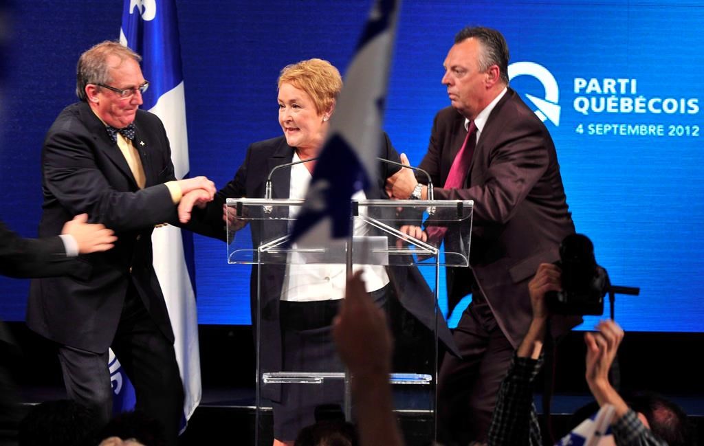 Parti Québécois Leader Pauline Marois is whisked off stage as she delivered her victory speech in Montreal, Tuesday, Sept. 4, 2012. 
