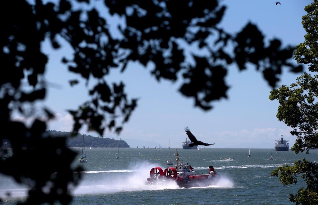 A Canadian Coast Guard hover craft travels on the waters of English Bay in Vancouver, B.C., on Saturday June 13, 2015. Mounties said on Tues. April 12, 2022, they are searching the waters and shore off Nanaimo, B.C., for a man who is believed to have drowned after falling off a sailboat. THE CANADIAN PRESS/Darryl Dyck.