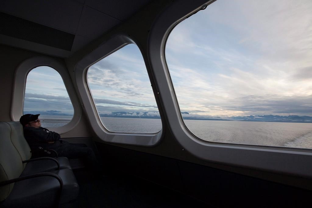 A passenger catches a nap as the morning light rises over the waters of Horseshoe Bay as the ferry Queen of Oak Bay departs for Nanaimo, B.C. early Tuesday, Sept. 7, 2010.