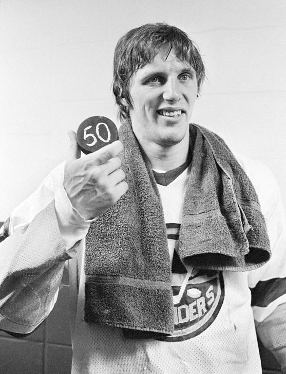New York Islanders' Mike Bossy holds a puck signifying his scoring 50 goals in his first 50 games, in Uniondale, N.Y., on Jan. 24, 1981. Bossy died on Thursday after a battle with lung cancer. He was 65.