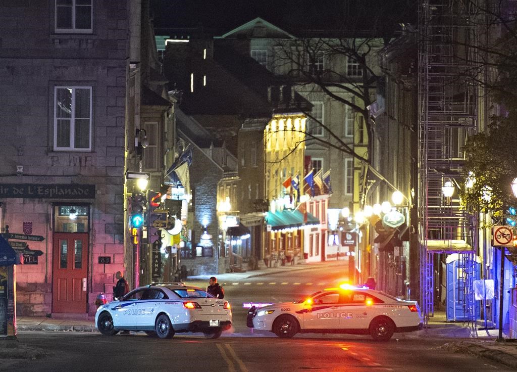 Police cars block St-Louis Street near Le Château Frontenac hotel, early Sunday, Nov. 1, 2020, in Quebec City.  