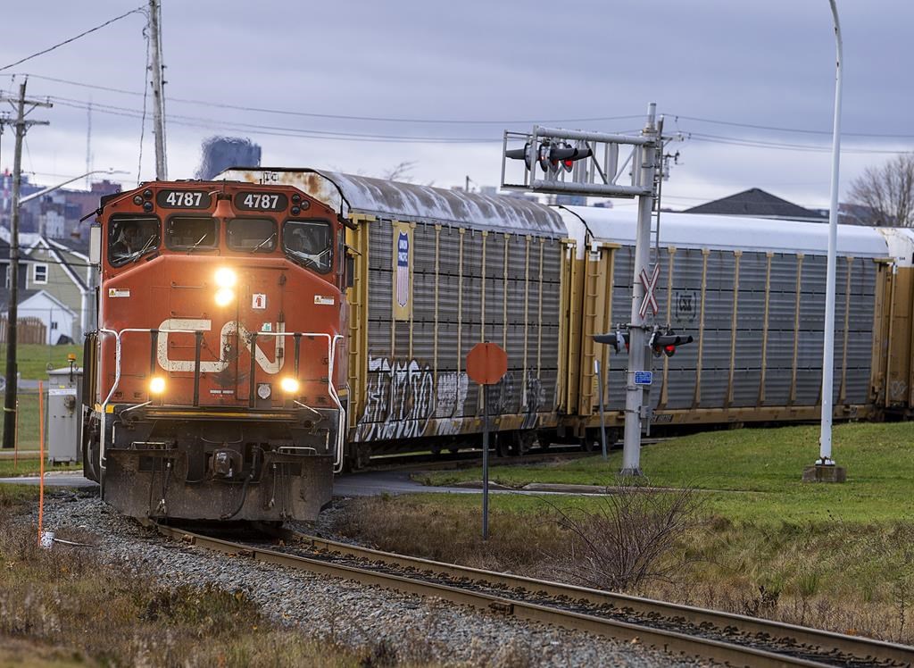 A CN Rail locomotive pulls auto carrier cars in Dartmouth, N.S. on Thursday, Nov. 25, 2021.