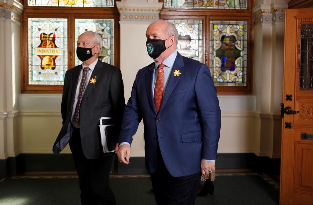 Minister of Indigenous Relations and Reconciliation Murray Rankin, left, and Premier John Horgan leave the chamber following the prorogation address in the chamber ahead of the throne speech at Legislature in Victoria, B.C., on Monday, April 12, 2021. The British Columbia government says First Nations, which have been hit hard by the pandemic and last year's wildfires and flooding, will receive a $74-million grant to make up for the loss of shared gaming revenues. THE CANADIAN PRESS/Chad Hipolito.