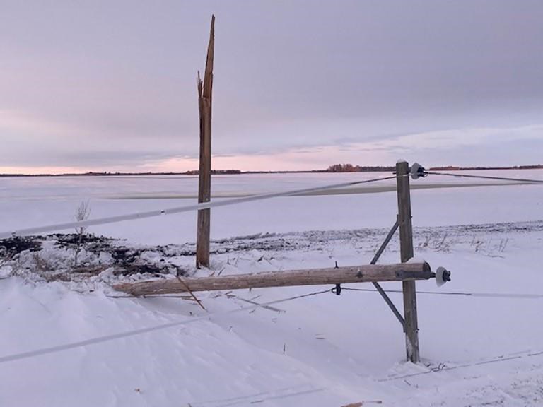 Utility poles were damaged by a weekend storm that brought heavy snow and strong winds to western Manitoba. .