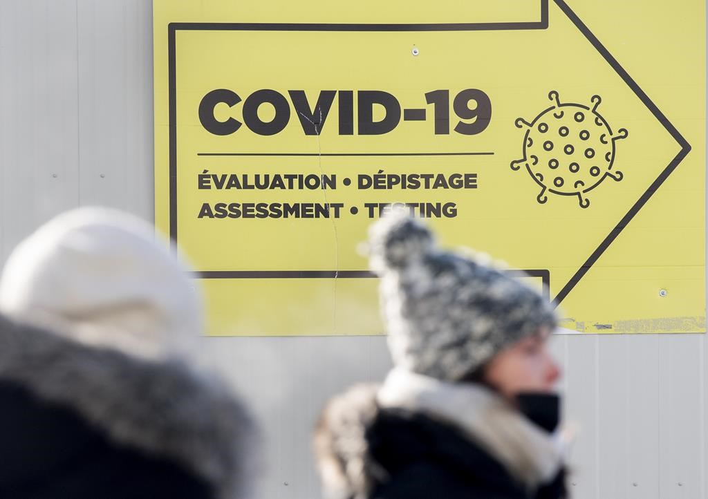 People are shown outside a COVID-19 testing site in Montreal, Saturday, Jan. 15, 2022. Quebec is reporting 23 additional deaths linked to COVID-19 and a 46-pateint decline in hospitalizations. 