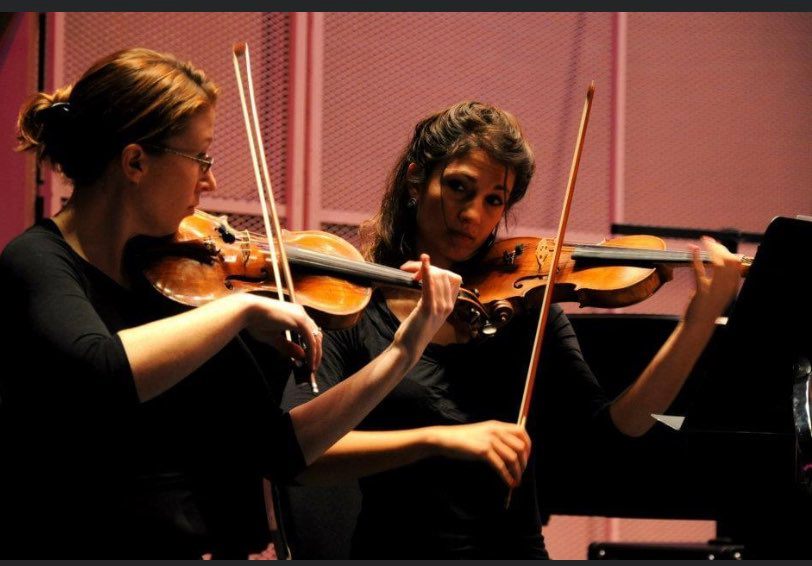 Katie Gannon(left) plays her rare violin with the Regina Symphony Orchestra.