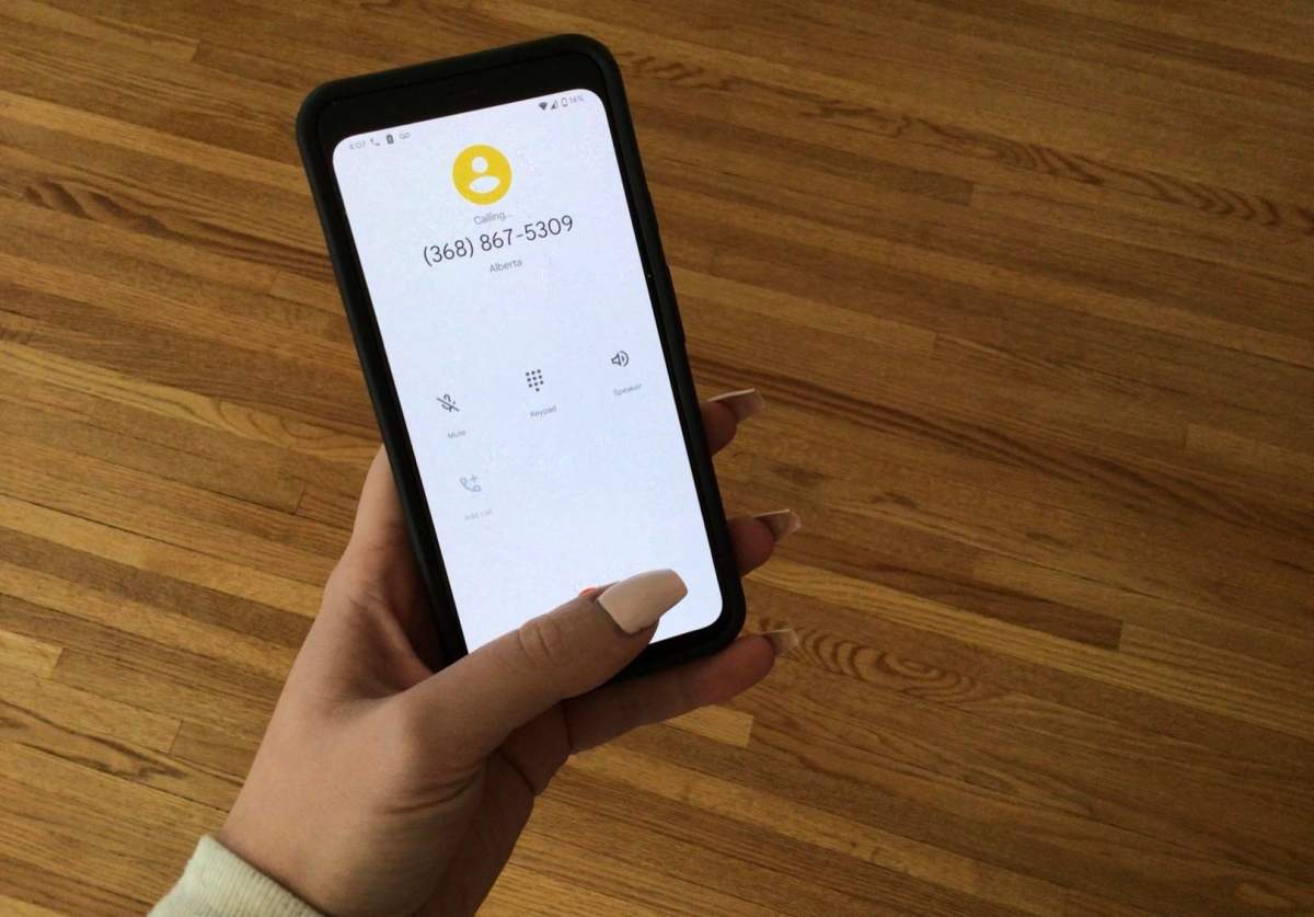 A file photo of a woman's hand holding a smatphone, about to call someone.