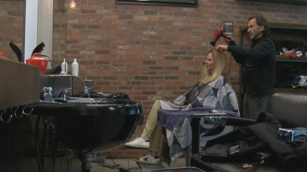 Business owner David Gandour services client at downtown hair salon