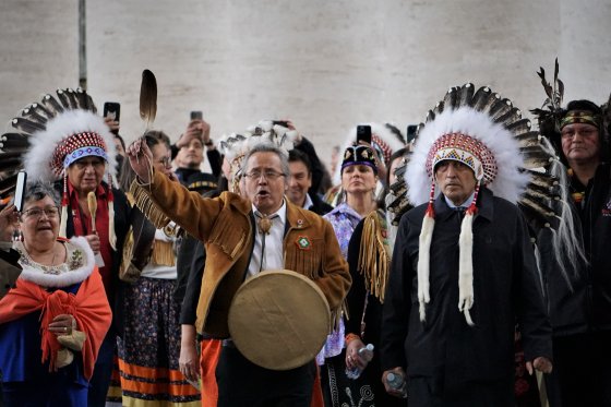 Delegation leader and Dene National Chief Gerald Antoine (centre) leads a procession out of Vatican City on April 1, 2022, after Pope Francis issued a historic apology related to residential schools in Canada. He is flanked by residential school survivors Adeline Webber and Phil Fontaine.