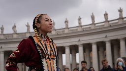 A jingle dress dancer performs outside St. Peter's Basilica in Vatican City on April 1, 2022.