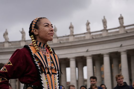 A jingle dress dancer performs outside St. Peter's Basilica in Vatican City on April 1, 2022.