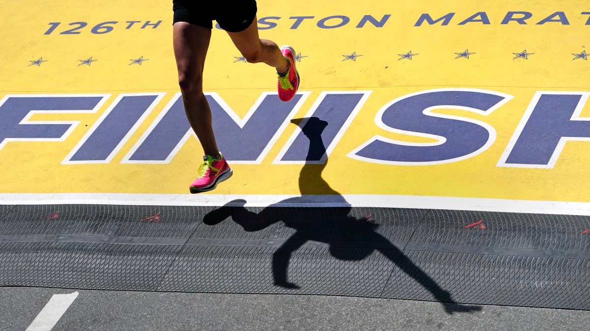 A runner crosses the finish line of the Boston Marathon, Monday, April 18, 2022, in Boston.